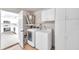 Laundry room with washer, dryer, cabinets and kitchen view at 9126 109Th Ter, Seminole, FL 33777