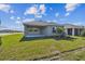 Exterior view of the home's backyard with a covered patio area at 11826 Richmond Trl, Parrish, FL 34219