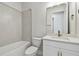Stylish bathroom featuring a shower-tub combo and white vanity at 11826 Richmond Trl, Parrish, FL 34219