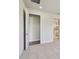 A carpeted bedroom with an open door to a walk in closet and a bathroom visible in the background at 11826 Richmond Trl, Parrish, FL 34219