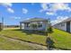 Charming single-story home with a well-manicured lawn and beautifully landscaped flowerbeds at 11826 Richmond Trl, Parrish, FL 34219
