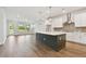 Open concept kitchen with stainless steel appliances, large island, and hardwood floors at 11826 Richmond Trl, Parrish, FL 34219