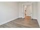 Modern office with wood-look floors, white walls, and glass paneled doors leading to other rooms at 11826 Richmond Trl, Parrish, FL 34219