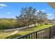 Balcony view of a tranquil green space with mature trees at 125 Mariner Dr # 125, Tarpon Springs, FL 34689