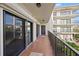 Spacious balcony with tile flooring, offering a view of neighboring buildings at 125 Mariner Dr # 125, Tarpon Springs, FL 34689