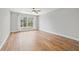Bright bedroom featuring hardwood floors and a large window at 125 Mariner Dr # 125, Tarpon Springs, FL 34689