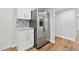 Modern kitchen with white cabinets, stainless steel refrigerator, and granite countertops at 125 Mariner Dr # 125, Tarpon Springs, FL 34689