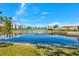 Serene pond with fountain, reflecting buildings and sky at 125 Mariner Dr # 125, Tarpon Springs, FL 34689