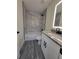 Renovated bathroom with a new vanity and marble-look tile at 1302 E Annie St, Tampa, FL 33612