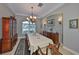 Formal dining room with a large table, chandelier, and hardwood floors at 1414 Alhambra Dr, Apollo Beach, FL 33572