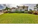 Two-story home with manicured lawn and lush landscaping at 1414 Alhambra Dr, Apollo Beach, FL 33572