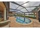 Relaxing pool area with covered patio and lake view at 1414 Alhambra Dr, Apollo Beach, FL 33572