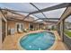 Inviting kidney-shaped pool with screened enclosure at 1414 Alhambra Dr, Apollo Beach, FL 33572