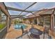 Outdoor entertaining space with pool and fire pit at 1414 Alhambra Dr, Apollo Beach, FL 33572