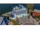 Aerial view of a modern home with unique architecture, a private pool, and waterfront access at 17410 1St E St, Redington Shores, FL 33708