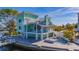 Elegant waterfront home with a multi-level deck, spiral staircase, and beautiful pool area at 17410 1St E St, Redington Shores, FL 33708
