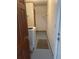 Bright laundry room featuring a white washing machine, shelving, and a gray rug on the neutral floor at 11253 Leland St, Spring Hill, FL 34609