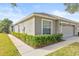 Side view of a tan house with a two-car garage at 4427 Ashton Meadows Way, Wesley Chapel, FL 33543