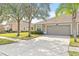 Two-car garage with a neatly landscaped front yard at 4427 Ashton Meadows Way, Wesley Chapel, FL 33543