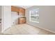 Kitchen nook with wood cabinets and a large window overlooking backyard at 4427 Ashton Meadows Way, Wesley Chapel, FL 33543