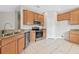 Modern kitchen with stainless steel appliances and wood cabinets at 4427 Ashton Meadows Way, Wesley Chapel, FL 33543