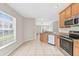 Bright kitchen featuring stainless steel appliances and light wood cabinets at 4427 Ashton Meadows Way, Wesley Chapel, FL 33543