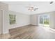 Living room with wood-look floors and access to a patio at 4427 Ashton Meadows Way, Wesley Chapel, FL 33543