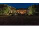 Landscaped backyard with lighting at night at 6007 Burrowing Owl Pl, Lithia, FL 33547