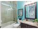 Guest bathroom with tub/shower combo, vanity, and stylish decor at 6007 Burrowing Owl Pl, Lithia, FL 33547