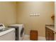 Well-lit laundry room, washer, dryer, and storage at 6007 Burrowing Owl Pl, Lithia, FL 33547