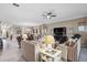 Bright and airy living area with ample seating, looking towards dining area at 6007 Burrowing Owl Pl, Lithia, FL 33547