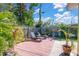 Landscaped backyard with patio and lounge chairs at 6500 7Th S Way, St Petersburg, FL 33705