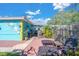 Colorful backyard oasis with patio and lounge chairs at 6500 7Th S Way, St Petersburg, FL 33705