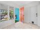 Inviting entryway with terracotta tile floors and coral door at 6500 7Th S Way, St Petersburg, FL 33705