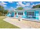 Bright teal home with surfboard house number at 6500 7Th S Way, St Petersburg, FL 33705