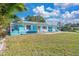 Charming light blue house with a spacious yard and palm trees at 6500 7Th S Way, St Petersburg, FL 33705