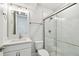 Modern bathroom with white vanity, quartz countertop and a glass shower at 709 W Orient St, Tampa, FL 33603