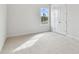 Bright bedroom with carpet, large window, and double door closet at 709 W Orient St, Tampa, FL 33603