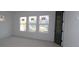 Bright bedroom with three windows and dark gray door at 709 W Orient St, Tampa, FL 33603