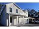 Two-story white farmhouse-style home with attached garage and landscaping at 709 W Orient St, Tampa, FL 33603