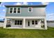 Two-story house with gray siding, white trim, and patio at 709 W Orient St, Tampa, FL 33603