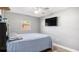 Bedroom with a ceiling fan and large TV at 139 Tennessee Ne Ave, St Petersburg, FL 33702