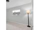 Bedroom with floor lamp and window offering natural light at 4444 Swift Rd # 20, Sarasota, FL 34231