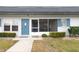 Neat exterior of a single-story home featuring a screened porch and blue shutter accents at 4444 Swift Rd # 20, Sarasota, FL 34231