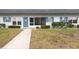 Front view of the house with a blue door and manicured lawn at 4444 Swift Rd # 20, Sarasota, FL 34231