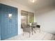 Inviting front porch featuring a blue door, neutral outdoor furniture, and bright natural light at 4444 Swift Rd # 20, Sarasota, FL 34231