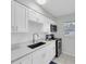 Modern kitchen with white shaker cabinets, quartz countertops, and stainless steel appliances at 4444 Swift Rd # 20, Sarasota, FL 34231