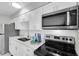 Updated kitchen featuring stainless steel appliances and white cabinetry at 4444 Swift Rd # 20, Sarasota, FL 34231