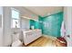 Modern bathroom with teal tile, double vanity, and walk-in shower at 10101 Eagle Preserve Dr, Englewood, FL 34224