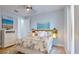 Guest bedroom with light walls, a comfortable bed, and tropical decor at 10101 Eagle Preserve Dr, Englewood, FL 34224